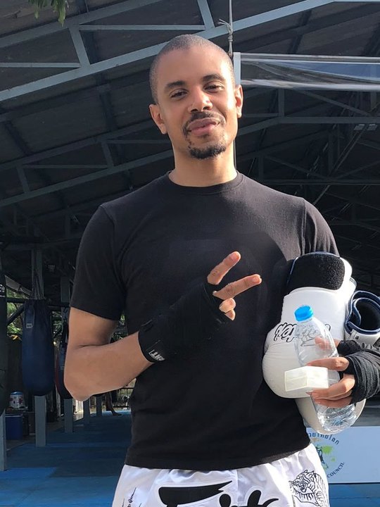 Idris, assistant coach, in hand wraps at a Muay Thai camp in Thailand