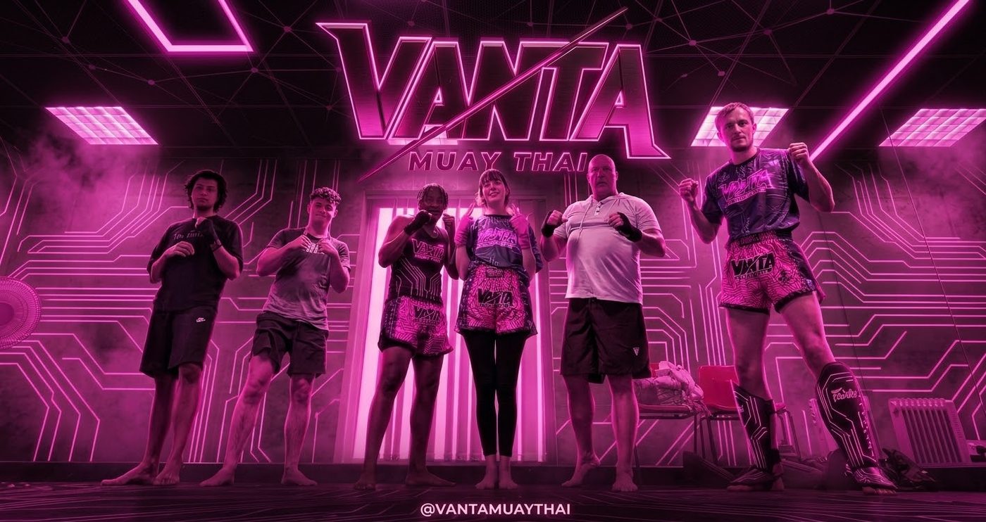 Vanta members under a pink neon Vanta sign